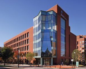 Red brick office building with all-glass front-facing facade.